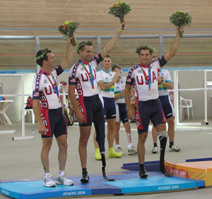 Ron Williams (center) and Paul Martin (right) acknowledge the crowd after being awarded their silver medals in the sprint time trials.
